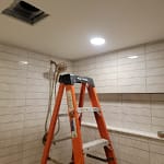 Wired and installed recessed lighting in home shower.